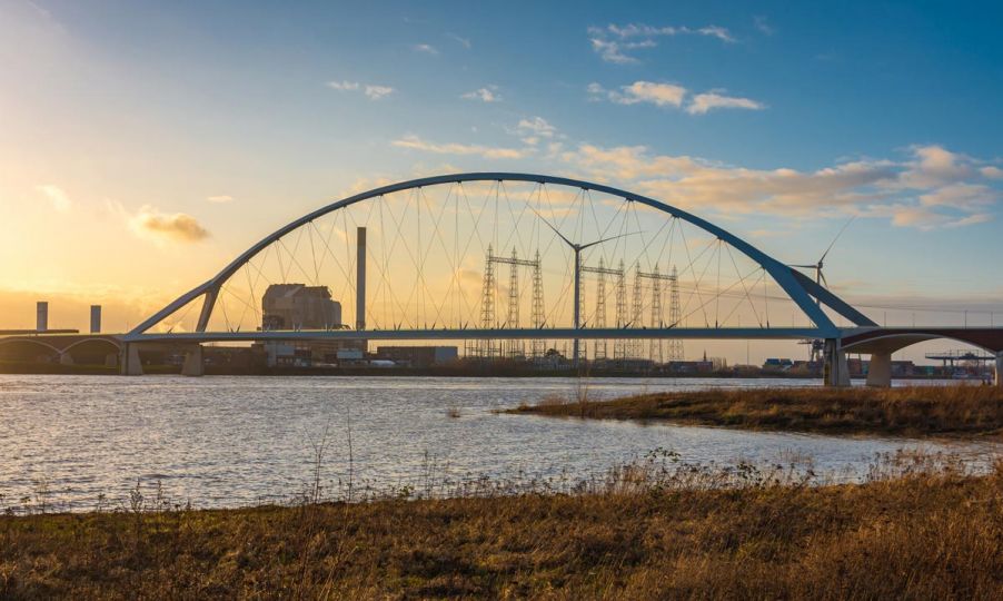 Bridge and a wind turbine with steel towers in the background