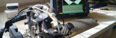 Evident AxSEAM long seam pipe scanner set up on a half-pipe standard with a longitudinal weld and an OmniScan X3 phased array flaw detector with full matrix capture (FMC) total focusing method (TFM) capabilities.